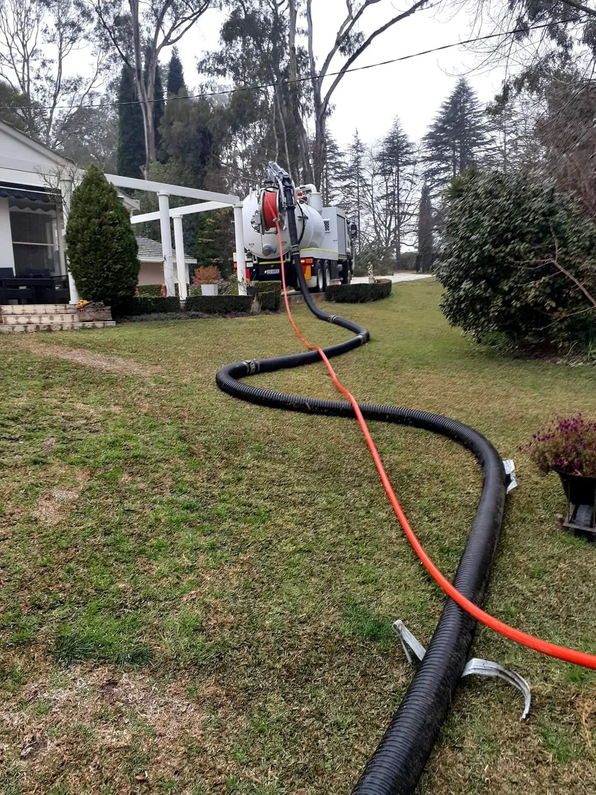 Drain-cleaning hoses connected to the City Coast vacuum truck